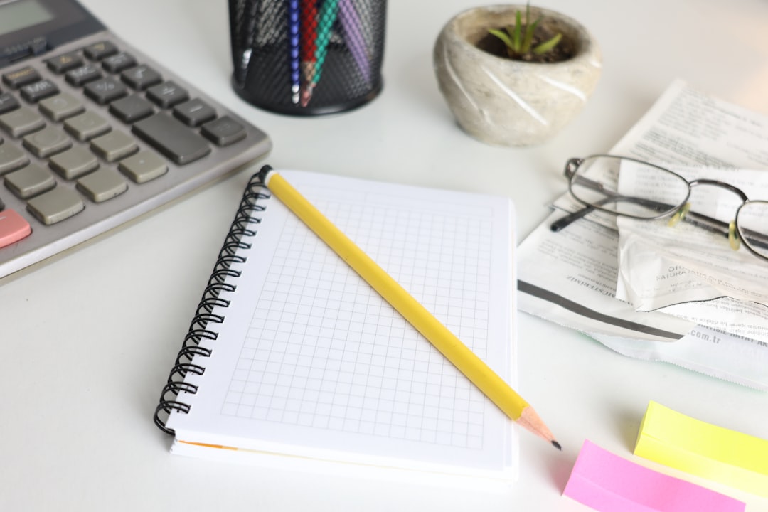 desk-with-calculator-notebook-pencil-and-glasses-amzgvqf0cgw